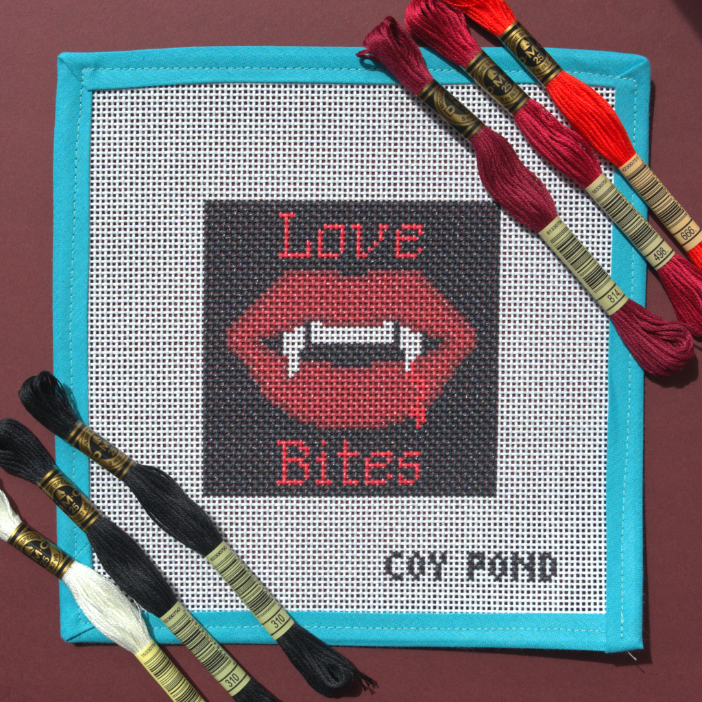 Romantasy Love Bites needlepoint starter kit - 13-count stitch printed canvas with red vampire lips and fangs on black background