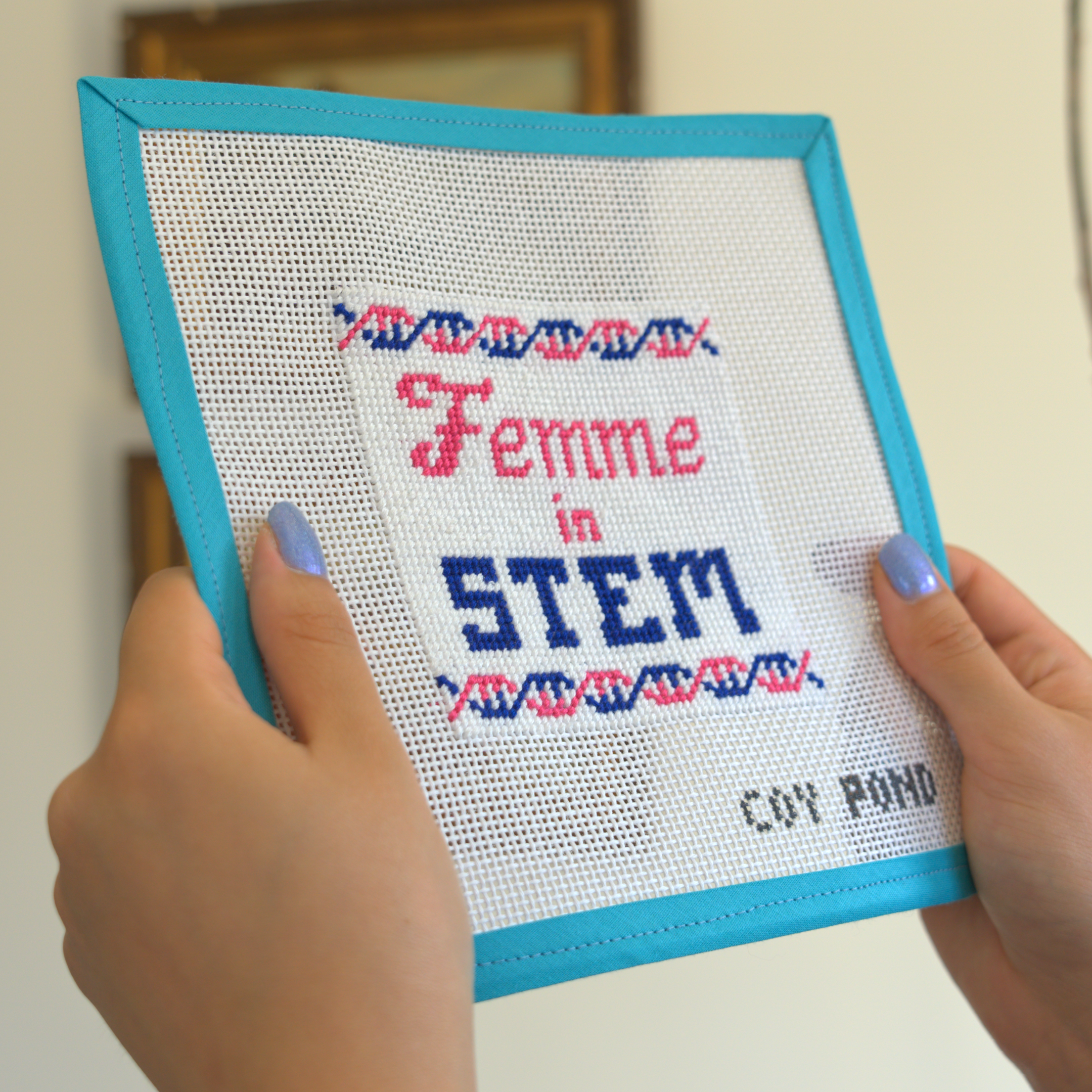 Femme in STEM DNA needlepoint kit - completed stitched canvas showing blue and pink double helix design