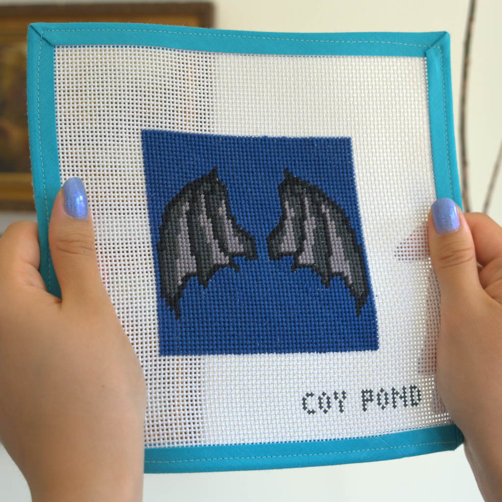 Romantasy Bat Wings needlepoint kit - completed stitched canvas showing bat wings on dark navy background